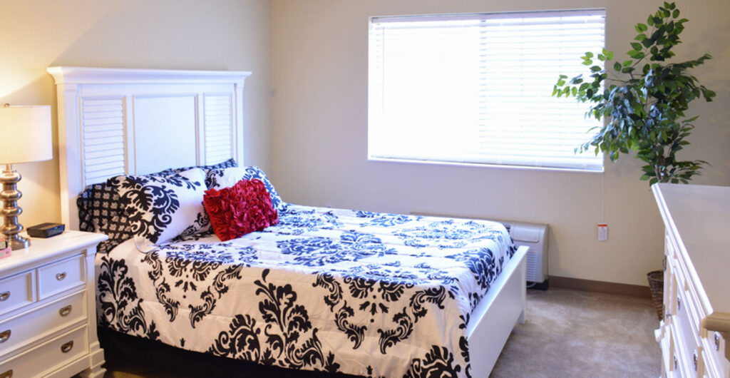 5605heritageoaksmodelbedwhite - Heritage Oaks Private resident bedroom at Heritage Oaks, a senior living community.